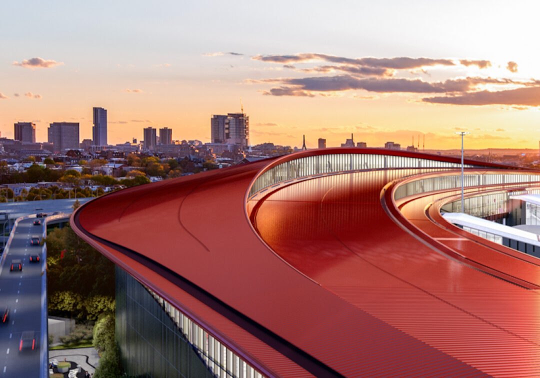 The curved red roof of Logan's Terminal E expansion at sunset